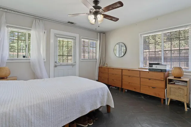 a view of living room filled with furniture and potted plants