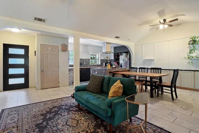 a living room with furniture and kitchen view