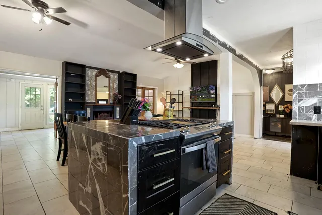 a kitchen with stainless steel appliances granite countertop a stove and a sink