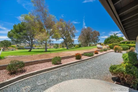 a view of a yard with cars parked