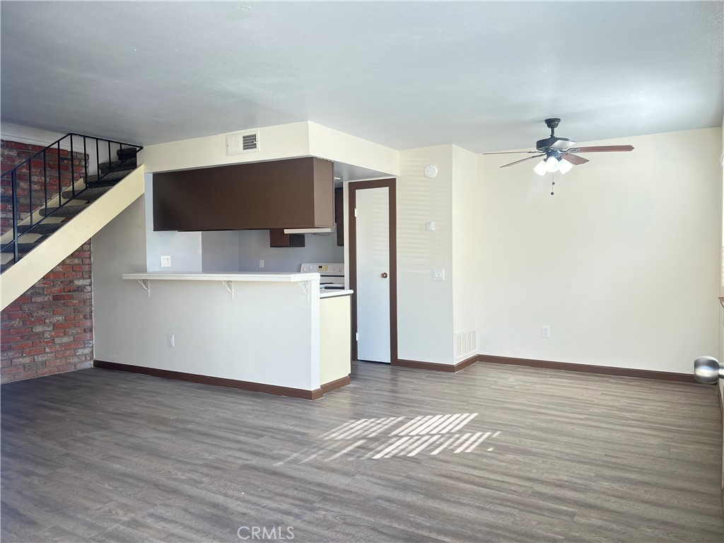 3535 20th Street Highland, CA 92346 - Photo 3 of 14 a view of a livingroom with a ceiling fan and wooden floor