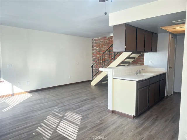 a utility room with wooden floor washer and dryer