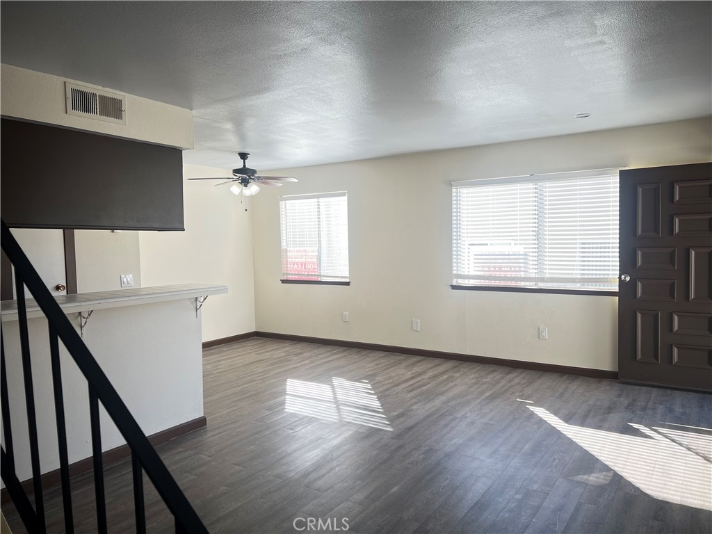 3535 20th Street Highland, CA 92346 - Photo 6 of 14 a view of an empty room with wooden floor and a window