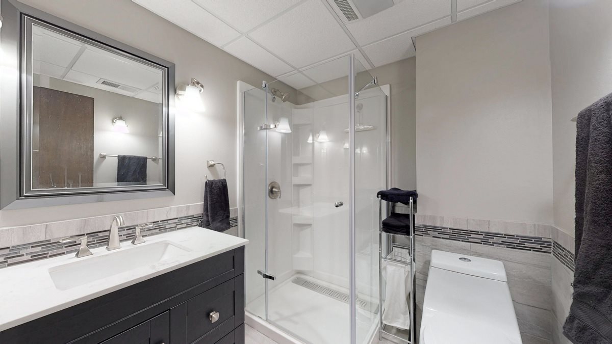 532 Baintree Road Lake Summerset, IL 61019 - Photo 17 of 25 a bathroom with a shower sink vanity granite and a mirror