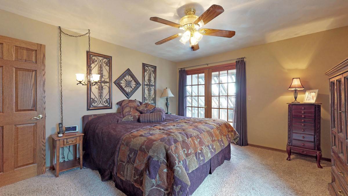 532 Baintree Road Lake Summerset, IL 61019 - Photo 21 of 25 a bedroom with a bed and a chandelier