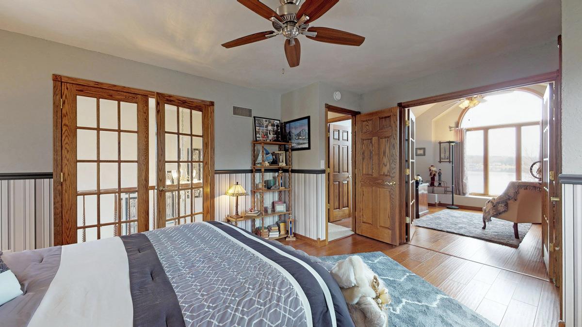 532 Baintree Road Lake Summerset, IL 61019 - Photo 22 of 25 a bedroom with a balcony a bed and a large window