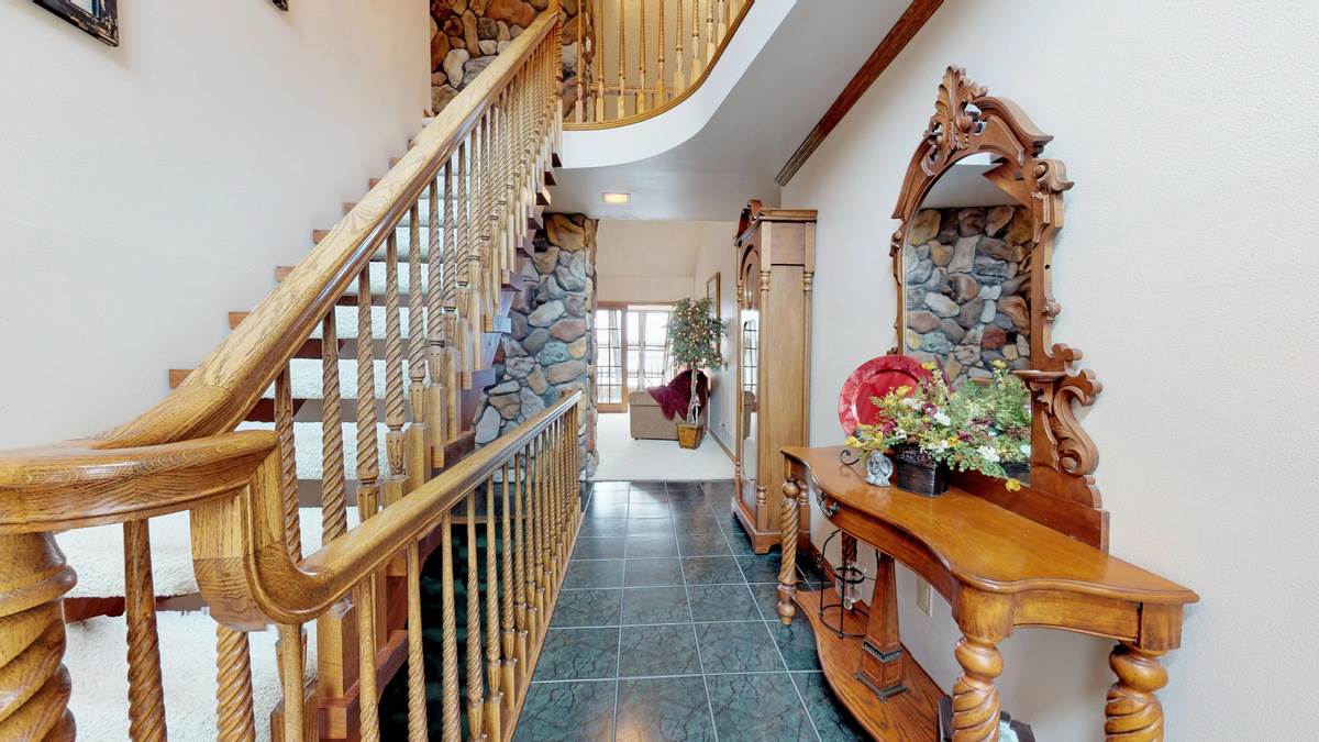 532 Baintree Road Lake Summerset, IL 61019 - Photo 3 of 25 a living room with wooden stairs and a potted plant