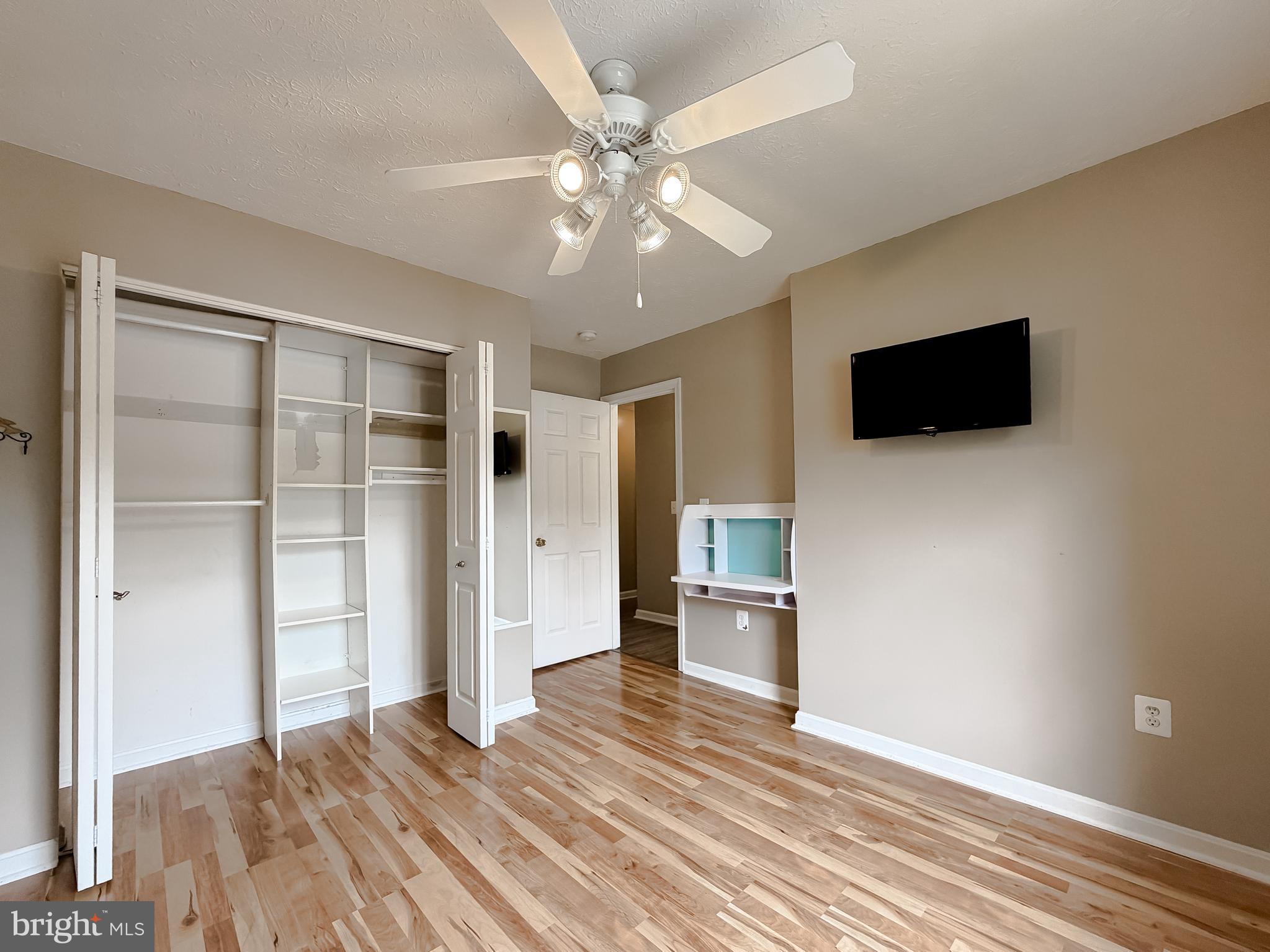 23801 McIntosh Road Hollywood, MD 20636 - Photo 18 of 35 a view of a livingroom with wooden floor and a ceiling fan