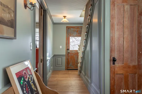 a view of an entryway with wooden floor