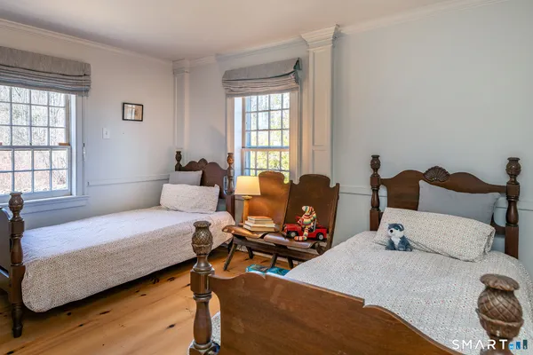 a bedroom with bed and window
