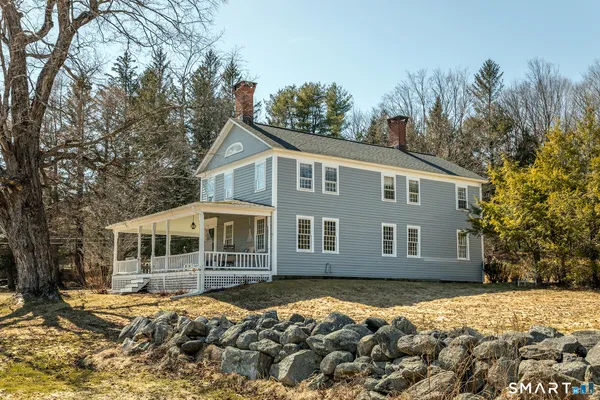 a view of a house with a small deck
