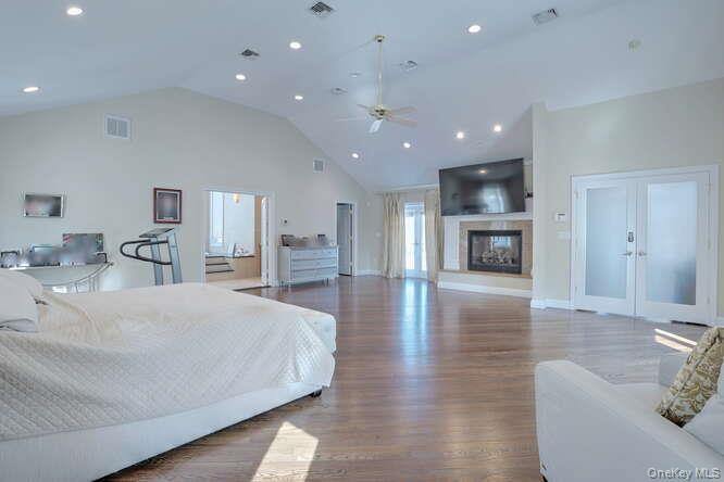 89 Spook Rock Road Suffern, NY 10901 - Photo 17 of 44 a spacious bedroom with a bed and a couch