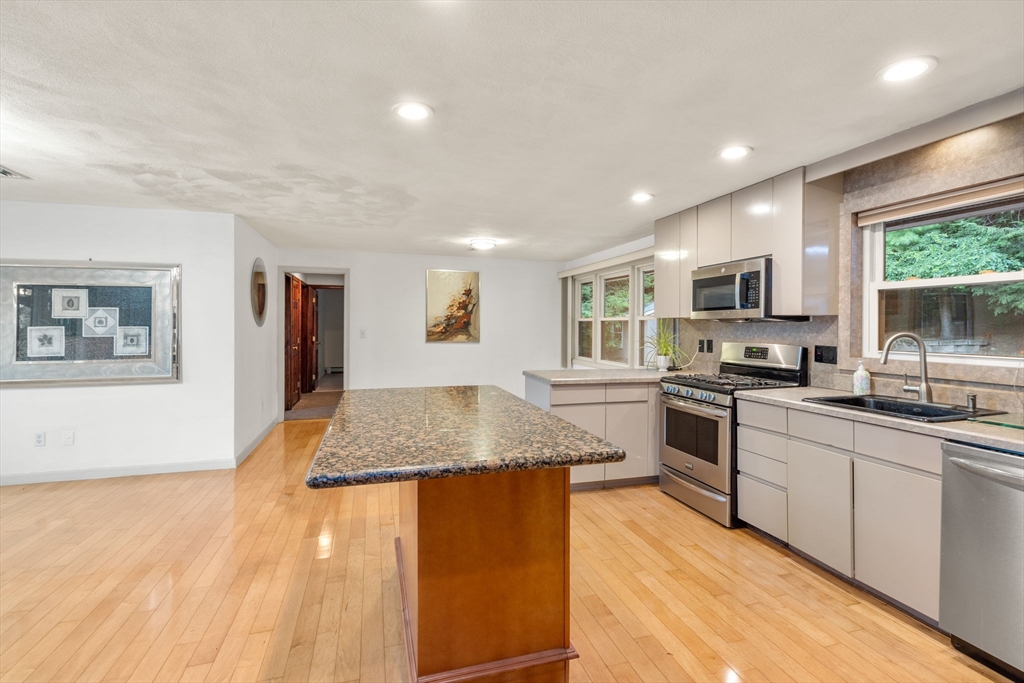 6 Paulette Drive Danvers, MA 01923 - Photo 18 of 35 a kitchen with stainless steel appliances granite countertop a sink stove and refrigerator