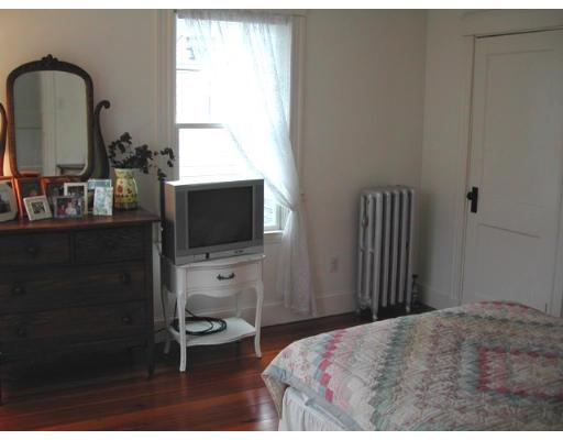 885 Webster Street Needham, MA 02492 - Photo 18 of 27 a bedroom with a bed and a flat tv screen on the dresser