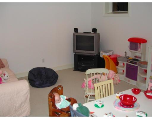 885 Webster Street Needham, MA 02492 - Photo 24 of 27 a bedroom with furniture and a flat screen tv