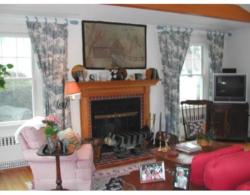 885 Webster Street Needham, MA 02492 - Photo 6 of 27 a living room with furniture a flat screen tv and a fireplace