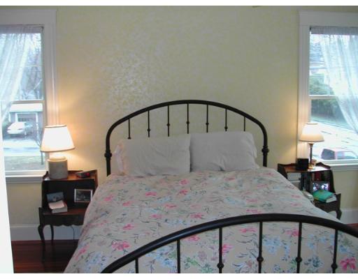 885 Webster Street Needham, MA 02492 - Photo 7 of 27 a bedroom with a bed a table and windows