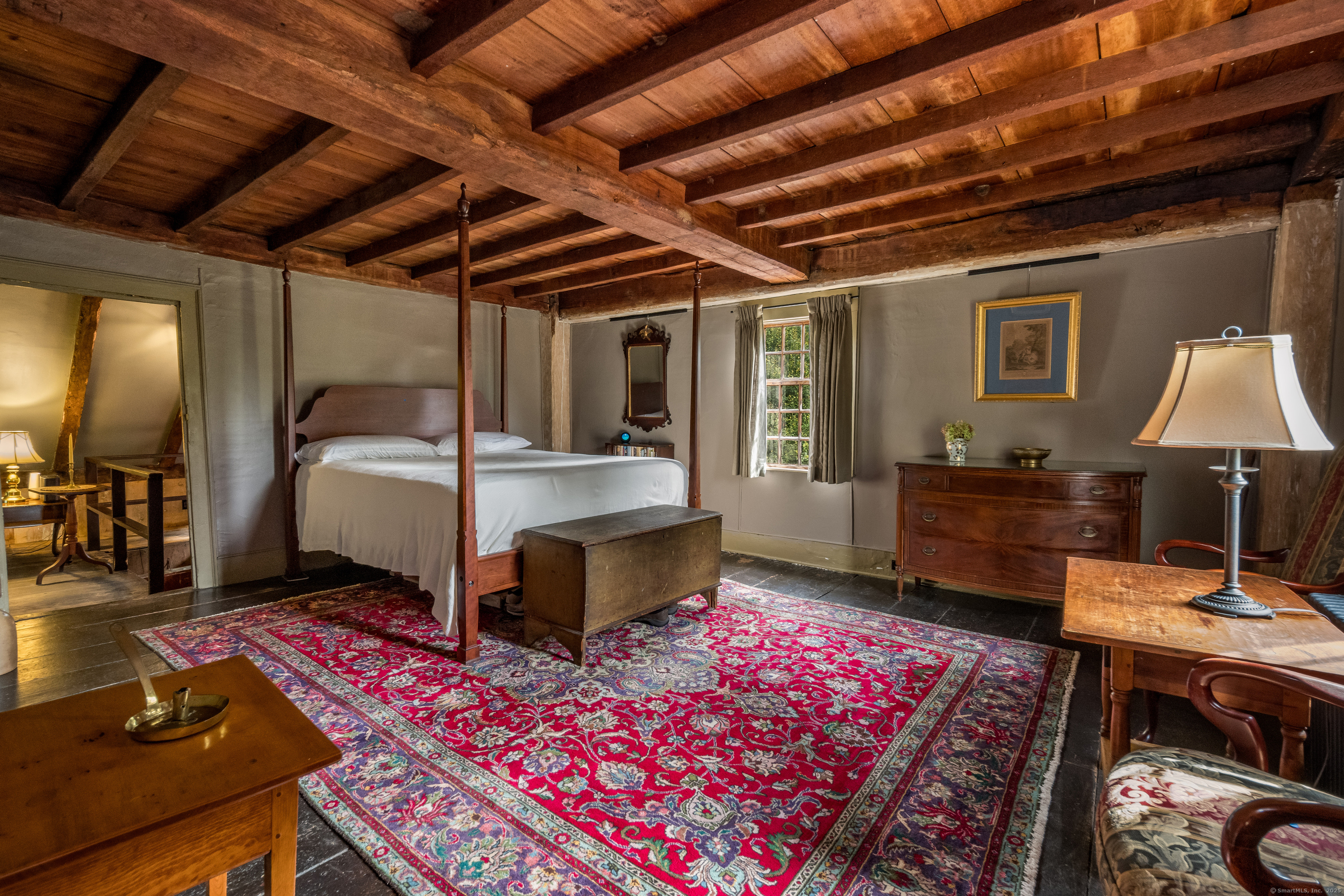 575 Leetes Island Road Guilford, CT 06437 - Photo 26 of 39 a bedroom with a bed a desk and chair