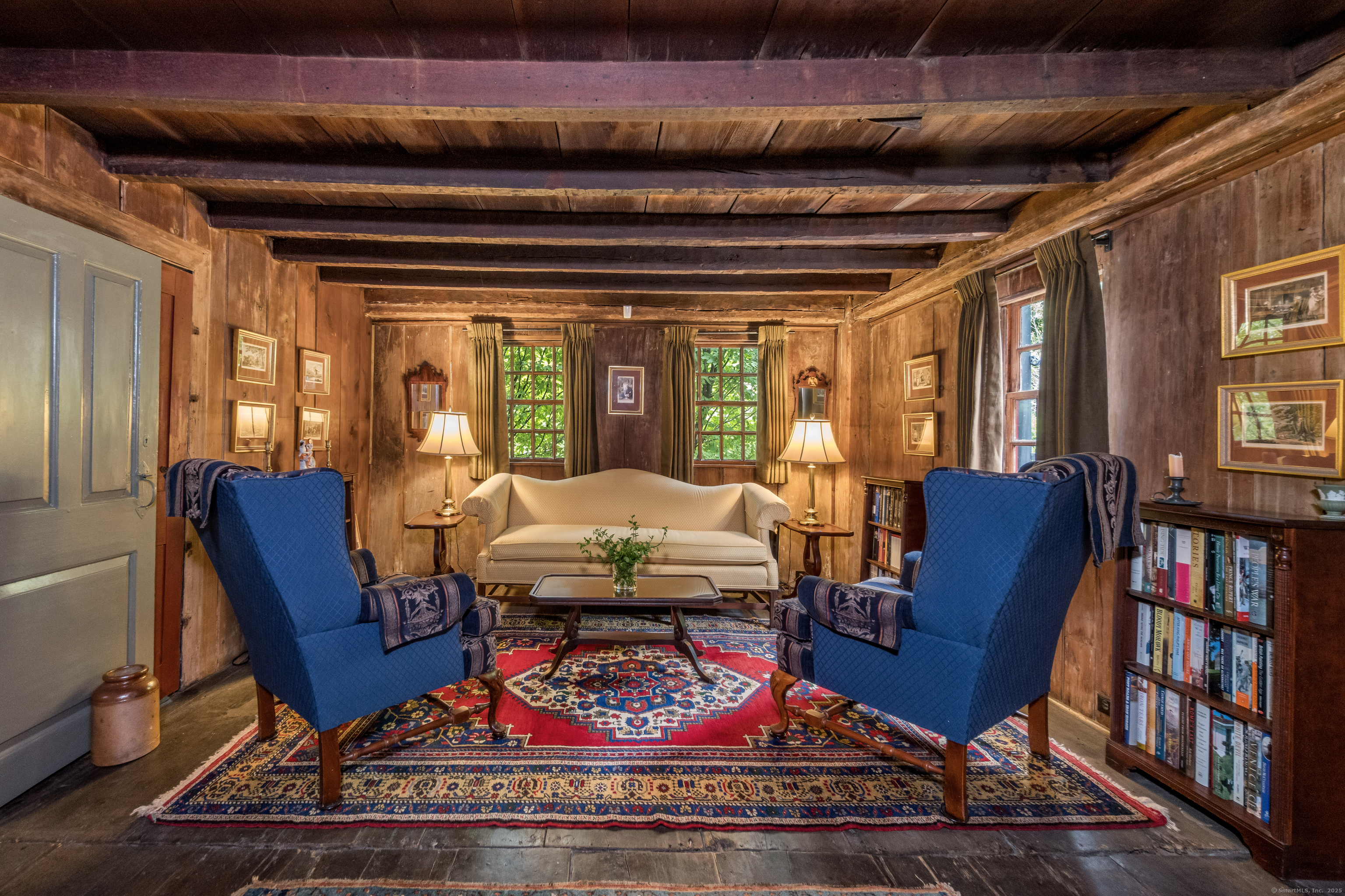 575 Leetes Island Road Guilford, CT 06437 - Photo 10 of 39 a living room with furniture a piano and a bookshelf