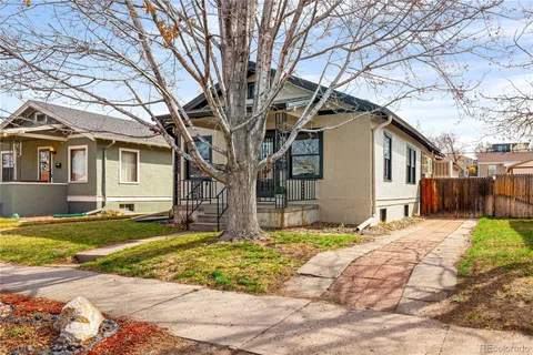 a house that has a tree in front of it