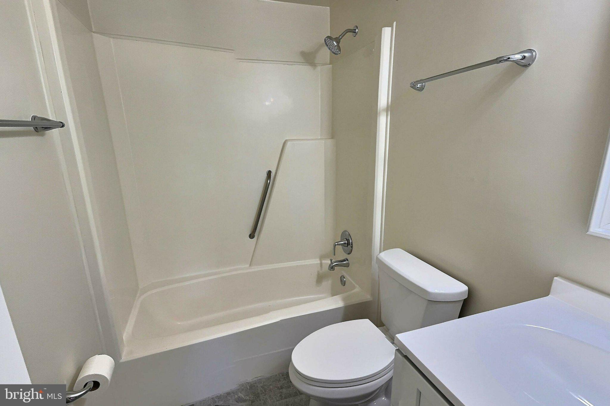 2001 Powder Horn Drive Fort Washington, MD 20744 - Photo 21 of 26 a white toilet and tub sitting next to a bathroom sink