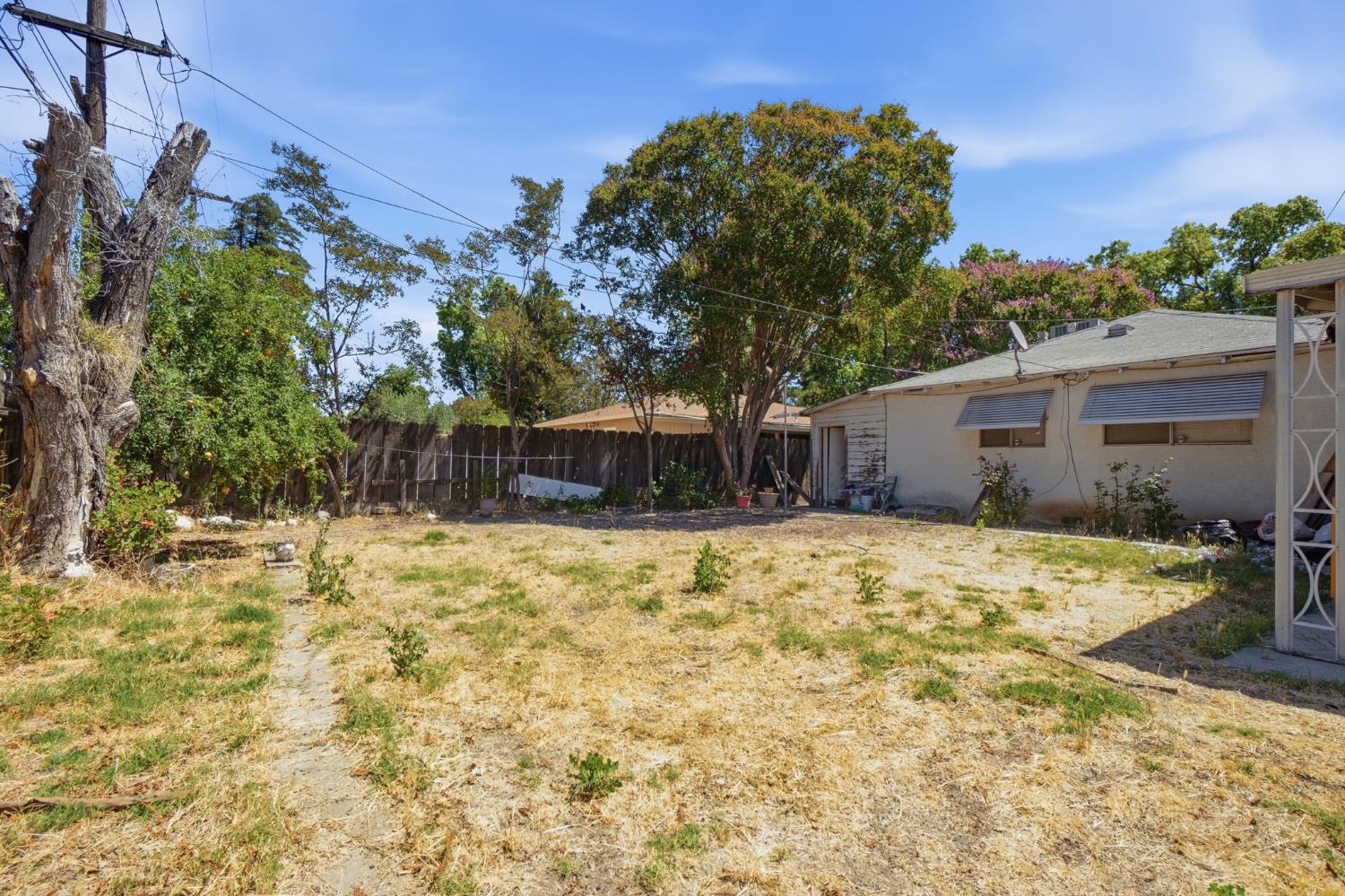 1705 Stetson Avenue Modesto, CA 95350 - Photo 24 of 32 a yellow house with trees in front of it