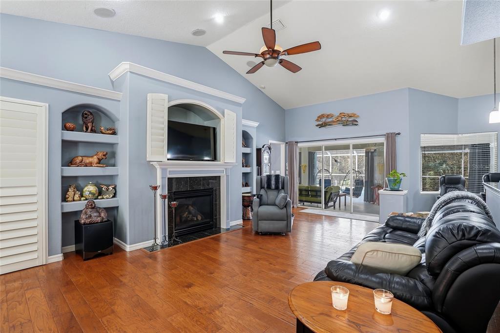 296 North Quartz Avenue Hernando, FL 34442 - Photo 16 of 66 a living room with furniture a fireplace and a flat screen tv