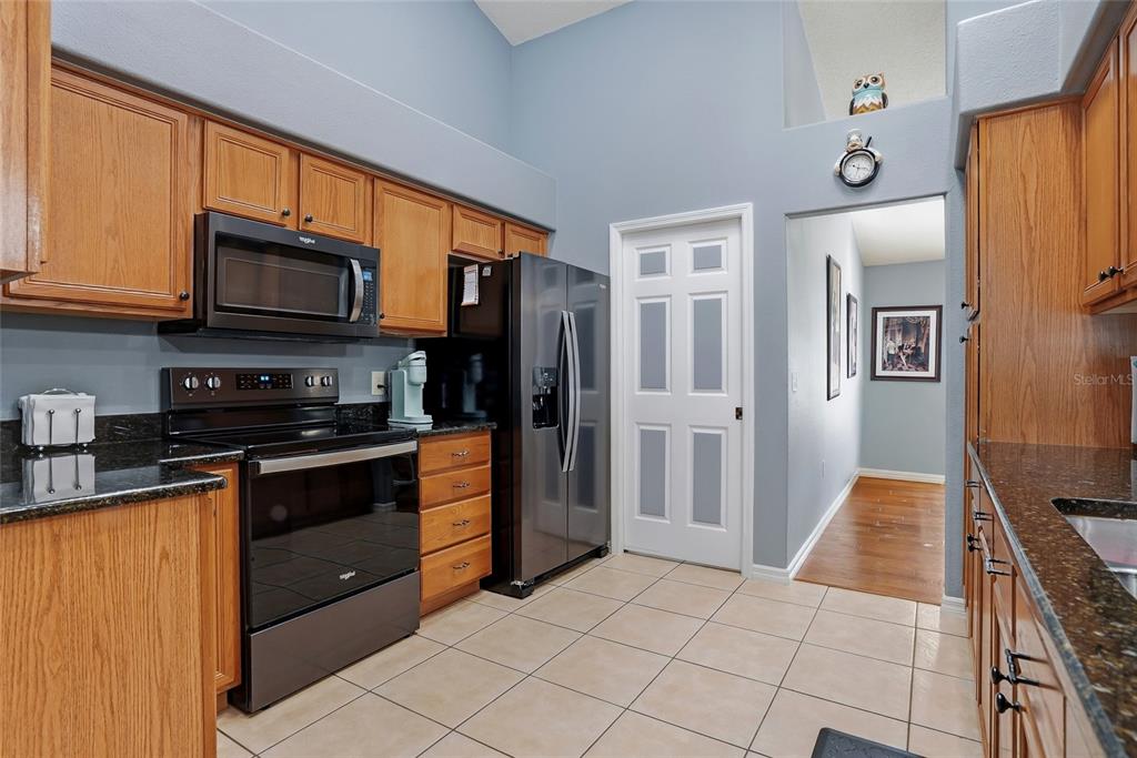 296 North Quartz Avenue Hernando, FL 34442 - Photo 19 of 66 a kitchen with stainless steel appliances granite countertop a refrigerator and a stove top oven