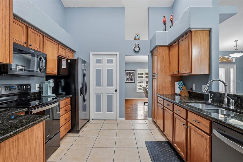 296 North Quartz Avenue Hernando, FL 34442 - Photo 20 of 66 a kitchen with stainless steel appliances granite countertop a stove top oven a sink dishwasher and a refrigerator