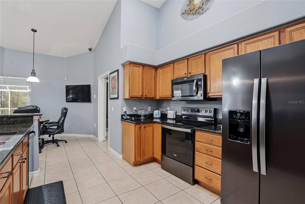296 North Quartz Avenue Hernando, FL 34442 - Photo 22 of 66 a kitchen with stainless steel appliances granite countertop a refrigerator stove microwave and sink