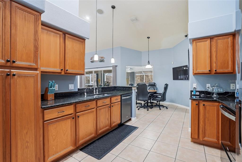 296 North Quartz Avenue Hernando, FL 34442 - Photo 23 of 66 a kitchen with stainless steel appliances granite countertop a stove a sink and a refrigerator