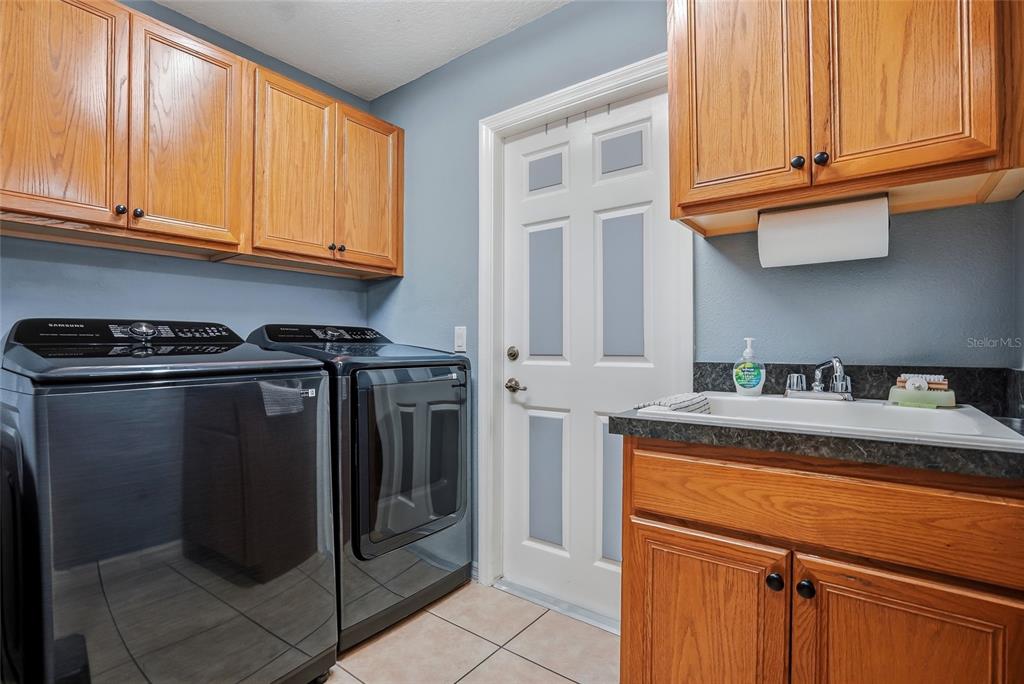 296 North Quartz Avenue Hernando, FL 34442 - Photo 24 of 66 a kitchen with stainless steel appliances granite countertop a refrigerator and a sink
