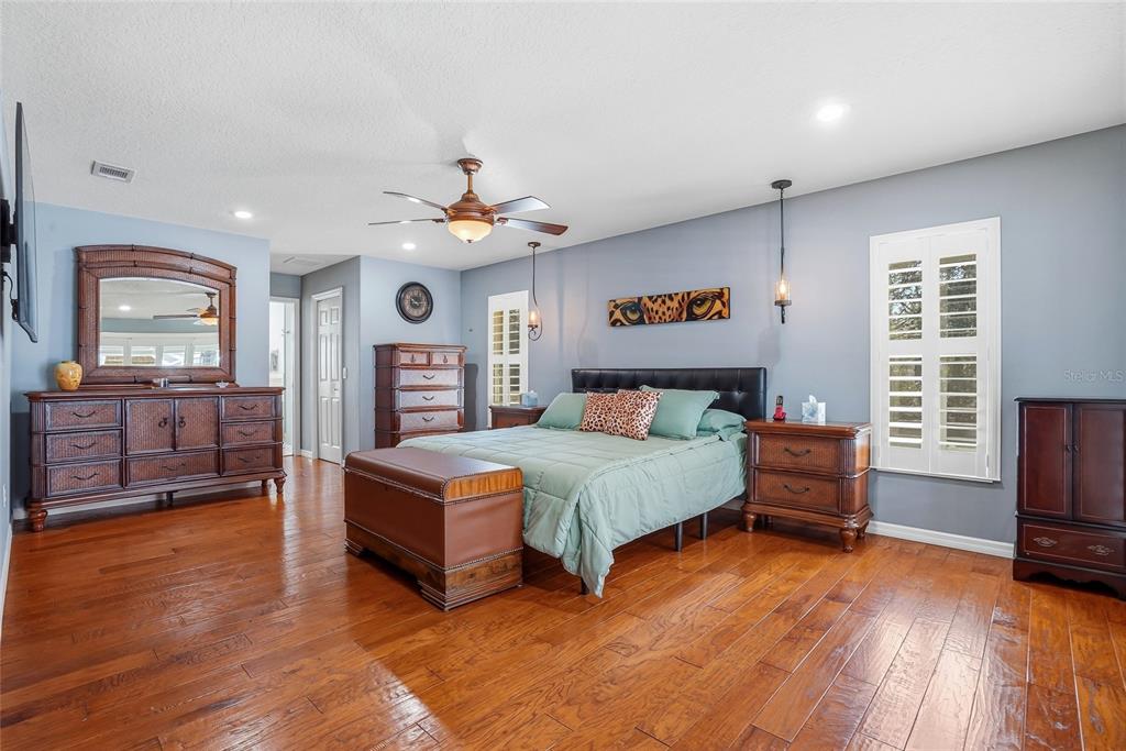 296 North Quartz Avenue Hernando, FL 34442 - Photo 25 of 66 a spacious bedroom with a bed and wooden floor