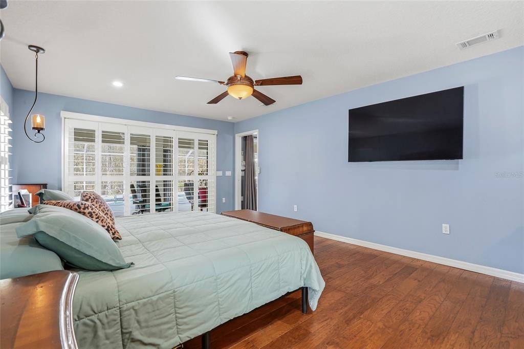 296 North Quartz Avenue Hernando, FL 34442 - Photo 26 of 66 a bedroom with a large bed and a flat screen tv