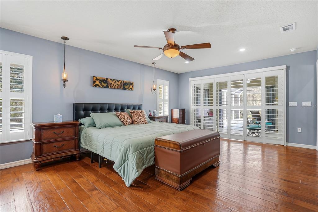 296 North Quartz Avenue Hernando, FL 34442 - Photo 27 of 66 a spacious bedroom with a bed and wooden floor