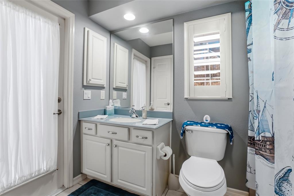 296 North Quartz Avenue Hernando, FL 34442 - Photo 34 of 66 a bathroom with a granite countertop toilet a sink and a mirror