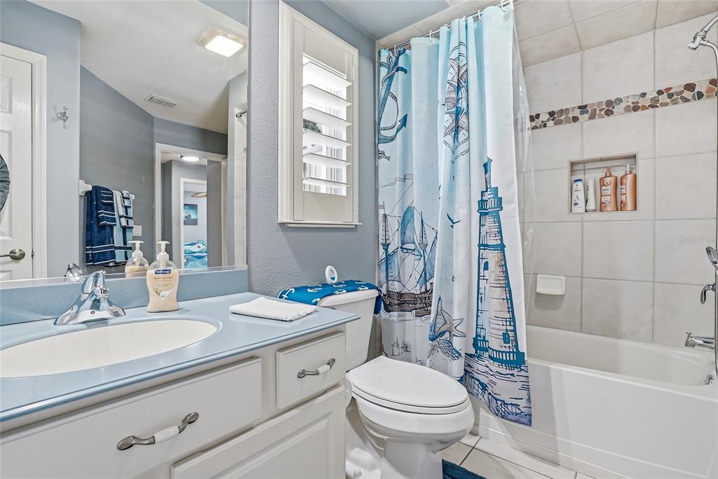 296 North Quartz Avenue Hernando, FL 34442 - Photo 35 of 66 a bathroom with a granite countertop sink a toilet a mirror a bathtub and shower