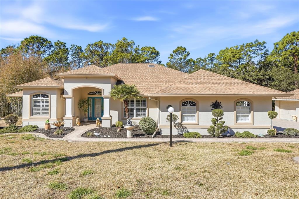 296 North Quartz Avenue Hernando, FL 34442 - Photo 6 of 66 a front view of a house with a patio