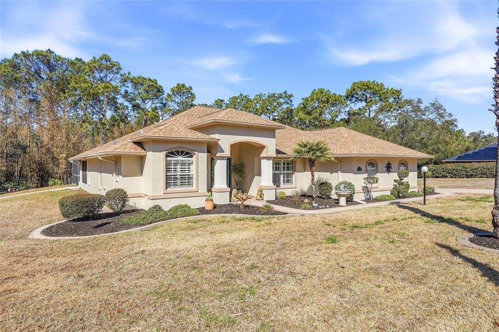 296 North Quartz Avenue Hernando, FL 34442 - Photo 7 of 66 a front view of a house with yard and seating area