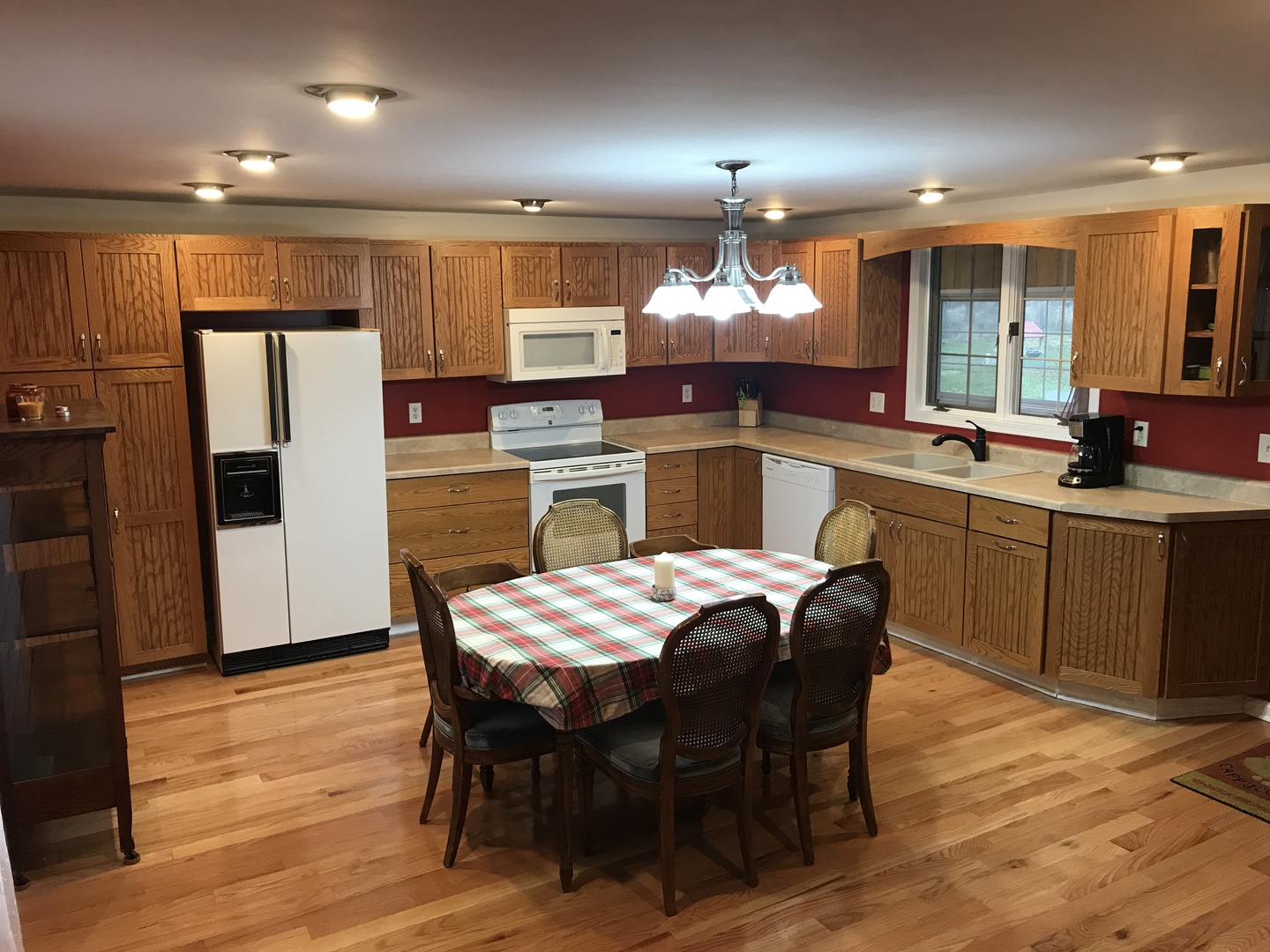 24562 Esmond Road Malta, IL 60150 - Photo 8 of 29 a kitchen with stainless steel appliances a dining table chairs refrigerator sink and cabinets