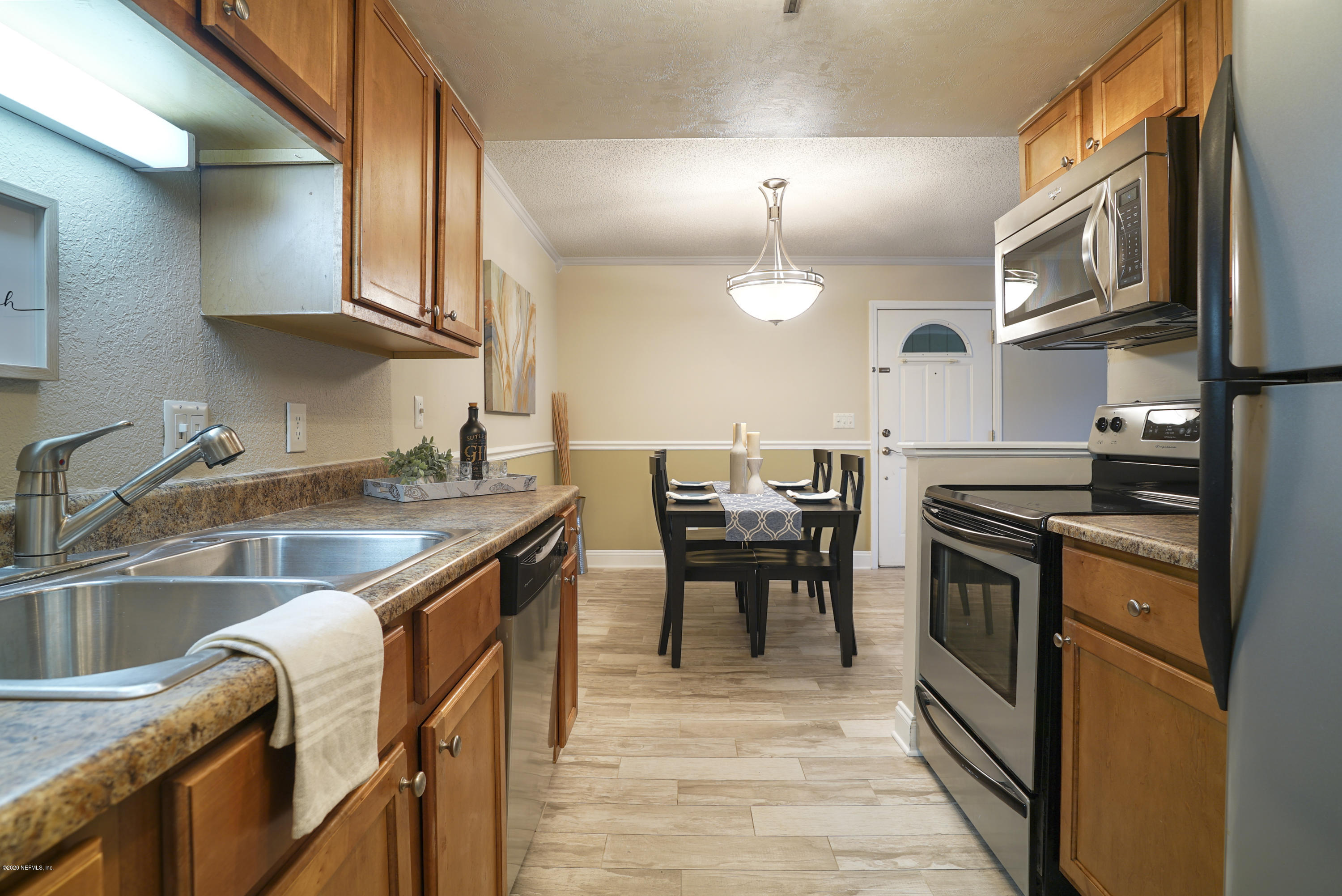 3737 Loretto Road, Unit 708 Jacksonville, FL 32223 - Photo 12 of 19 a kitchen with granite countertop a sink stove and cabinets