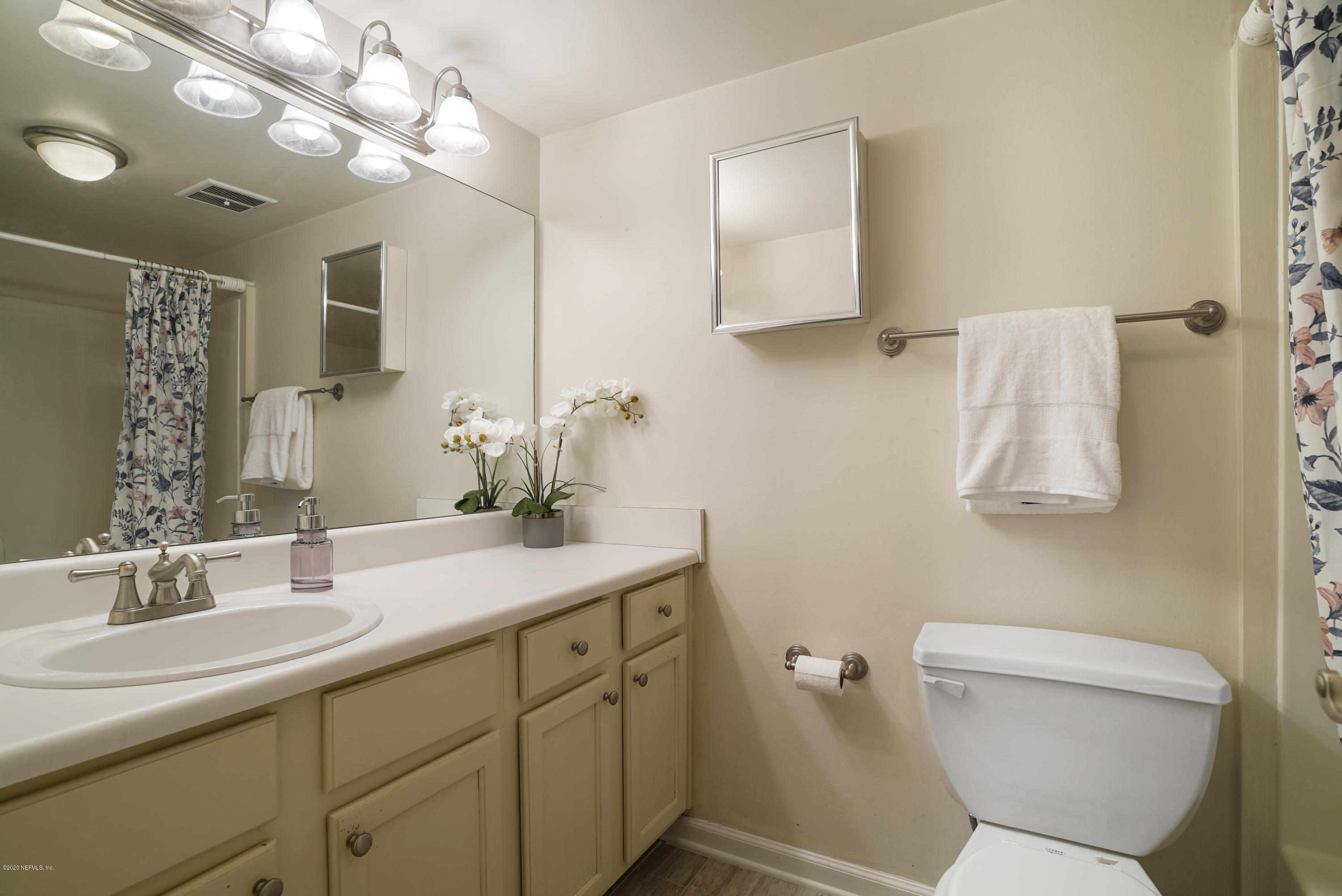 3737 Loretto Road, Unit 708 Jacksonville, FL 32223 - Photo 17 of 19 a bathroom with a sink a toilet and a mirror