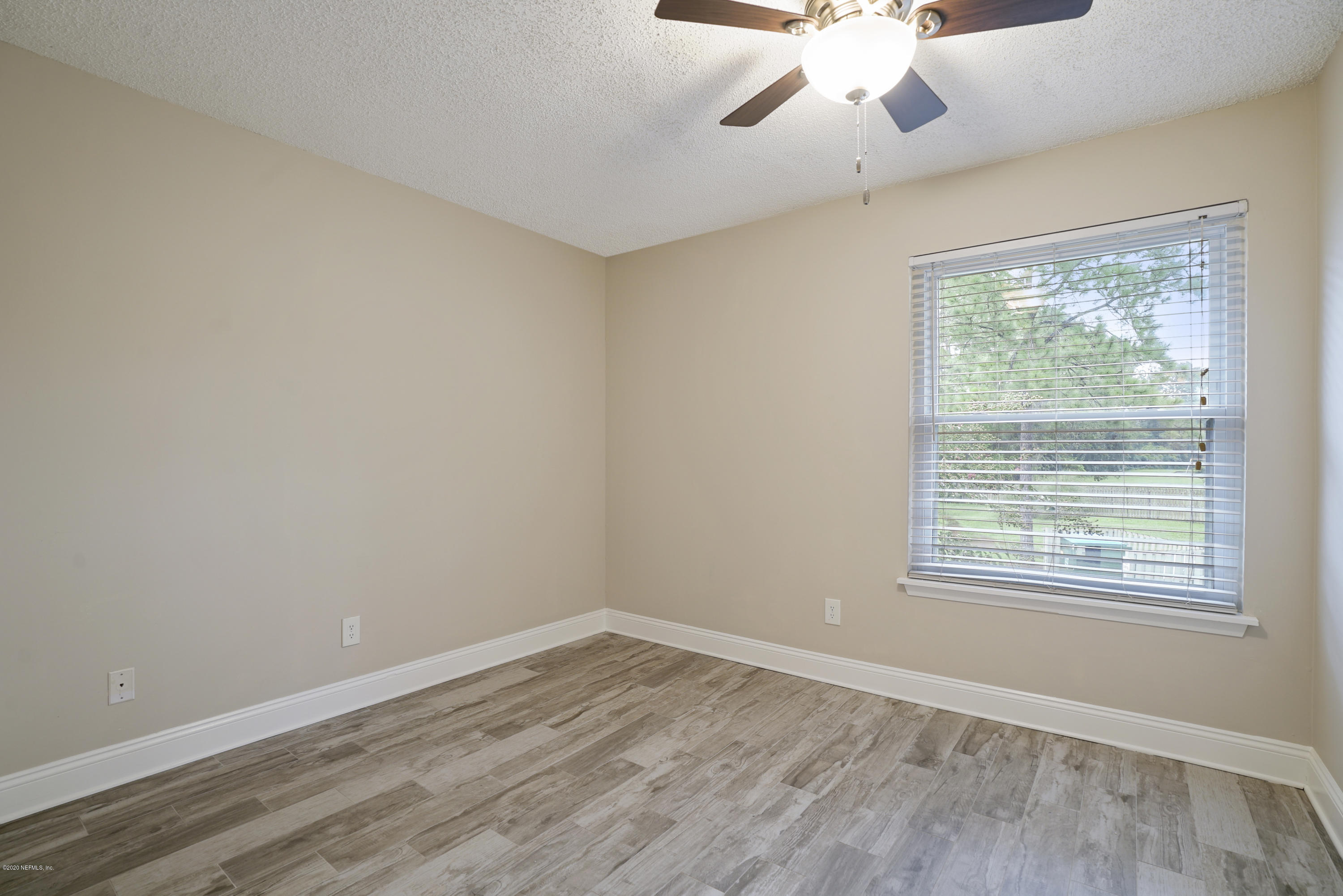 3737 Loretto Road, Unit 708 Jacksonville, FL 32223 - Photo 19 of 19 a view of an empty room with wooden floor and a window