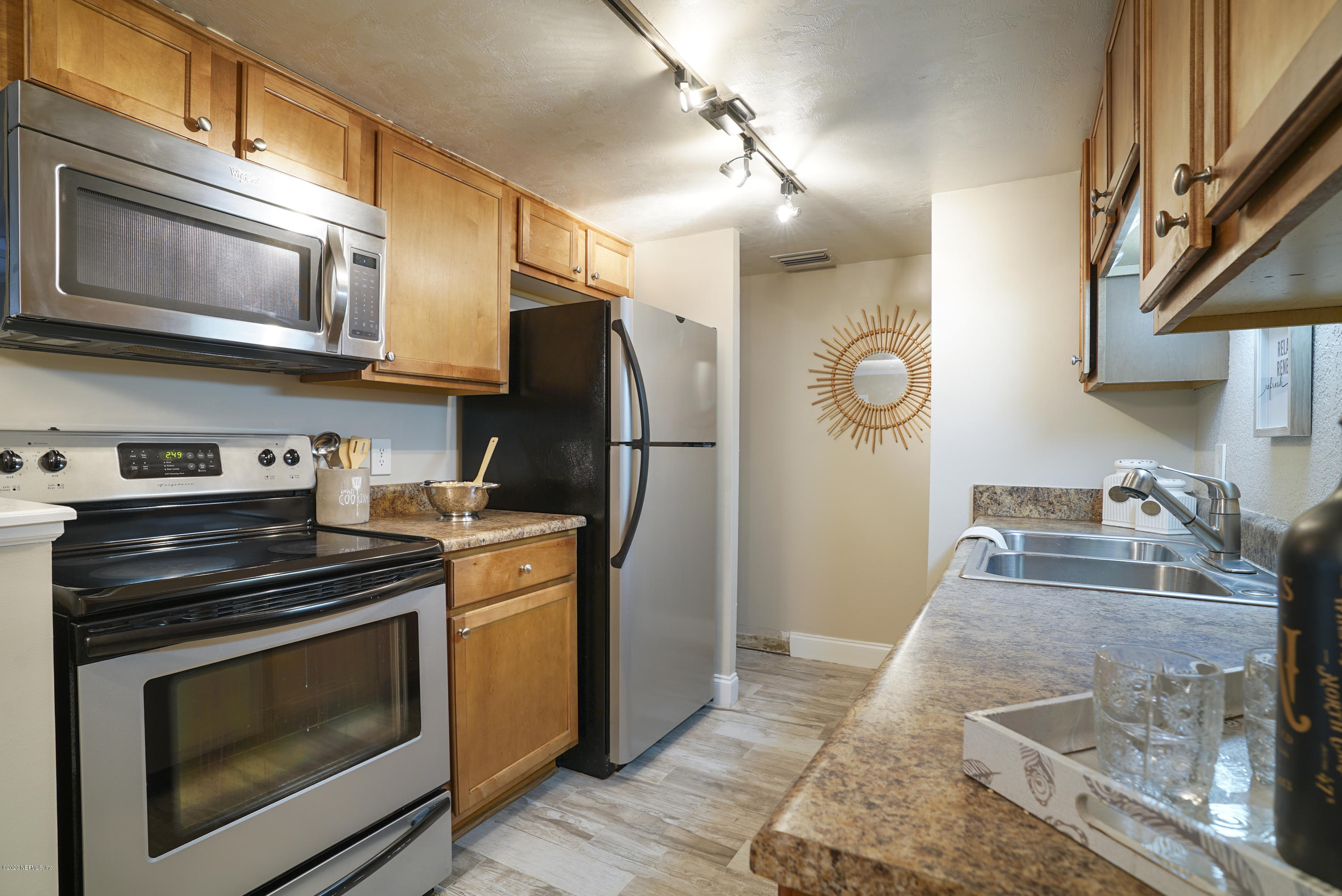 3737 Loretto Road, Unit 708 Jacksonville, FL 32223 - Photo 2 of 19 a kitchen with stainless steel appliances granite countertop a stove microwave and refrigerator