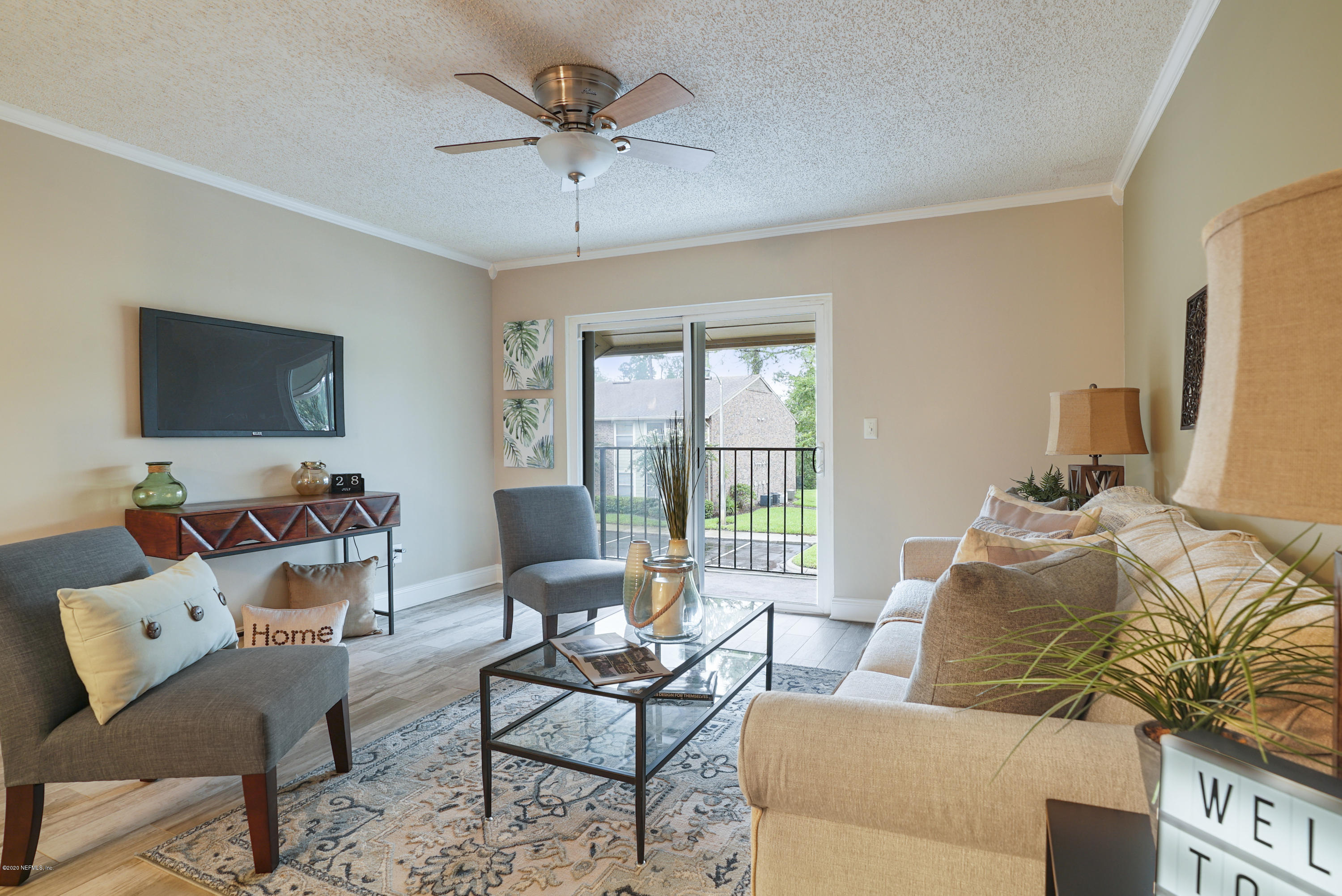 3737 Loretto Road, Unit 708 Jacksonville, FL 32223 - Photo 3 of 19 a living room with furniture and a flat screen tv