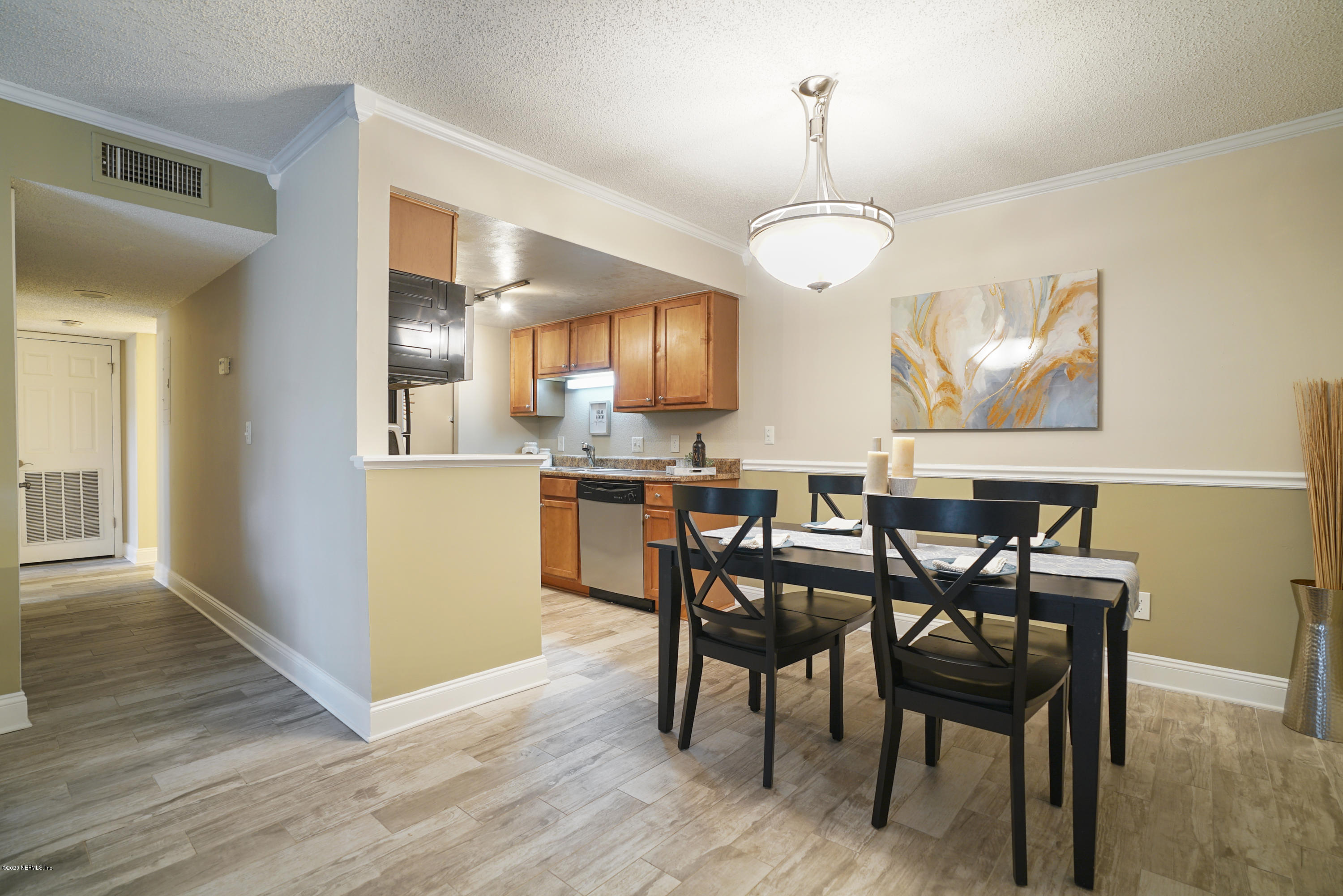 3737 Loretto Road, Unit 708 Jacksonville, FL 32223 - Photo 4 of 19 a view of a dining room with furniture and wooden floor