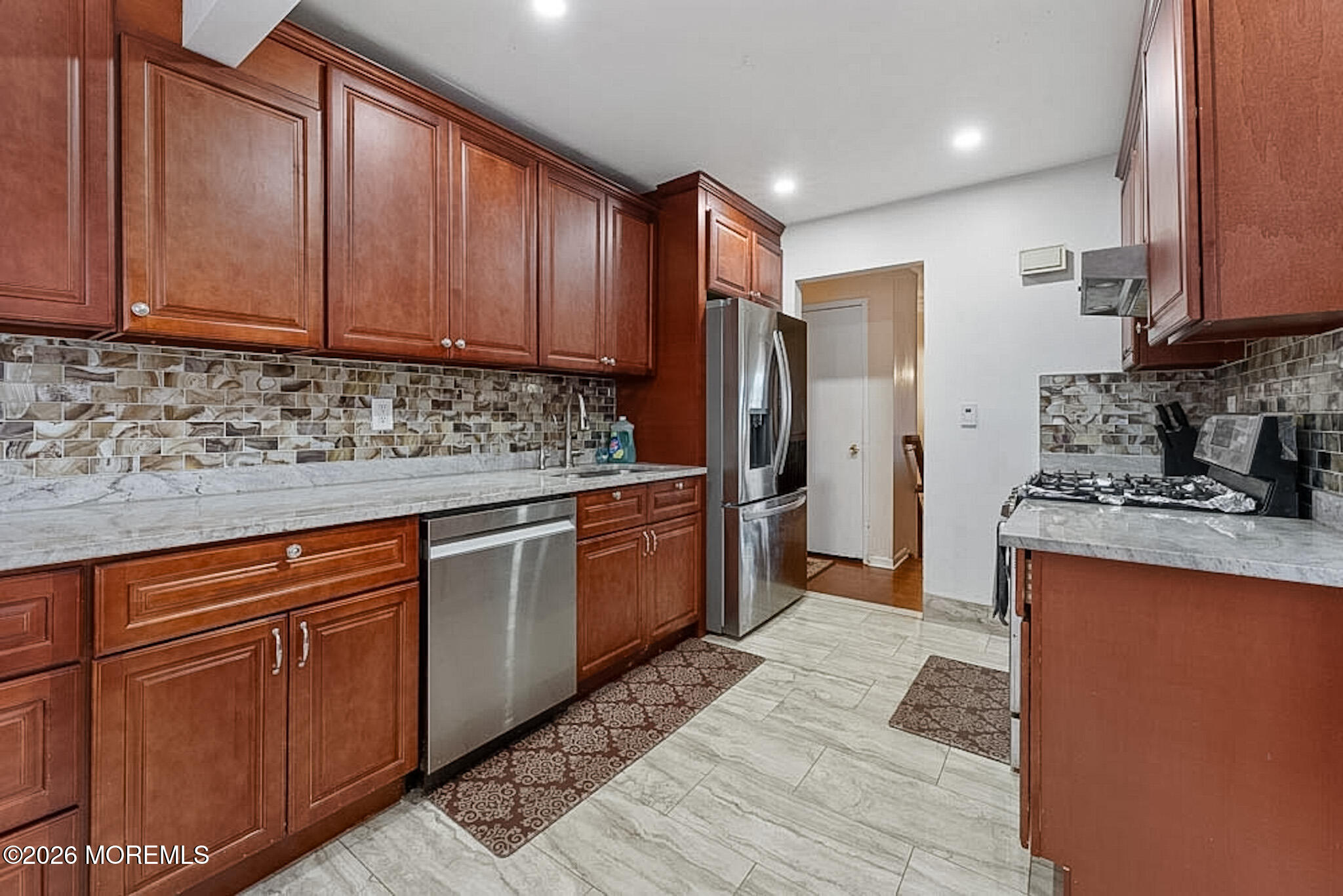 9 Neal Street Jackson, NJ 08527 - Photo 11 of 35 a kitchen with stainless steel appliances granite countertop a sink stove and refrigerator