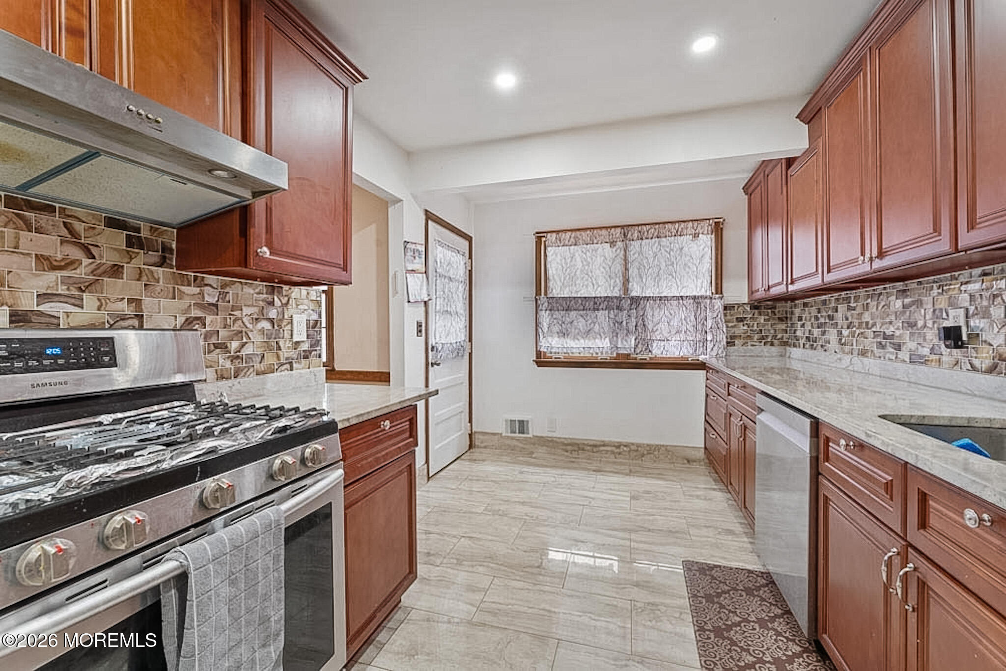 9 Neal Street Jackson, NJ 08527 - Photo 12 of 35 a kitchen with stainless steel appliances granite countertop a stove a sink and a microwave