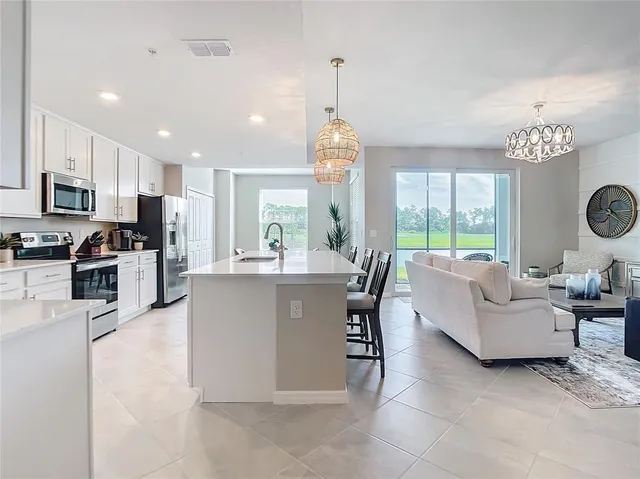 a kitchen with white cabinets and appliances