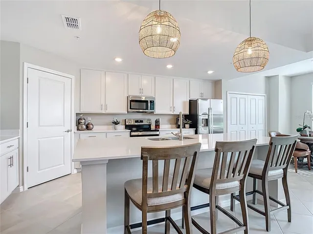 a kitchen with a sink and a refrigerator
